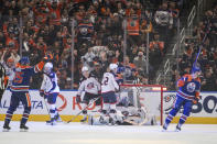 Columbus Blue Jackets' Boone Jenner (38), Damon Severson (78), Jake Bean (22) and goalie Elvis Merzlikins (90) react as Edmonton Oilers' Darnell Nurse (25) and Mattias Ekholm (14) celebrate an Oilers goal during the first period of an NHL hockey game Tuesday, Jan. 23, 2024, in Edmonton, Alberta. (Amber Bracken/The Canadian Press via AP)