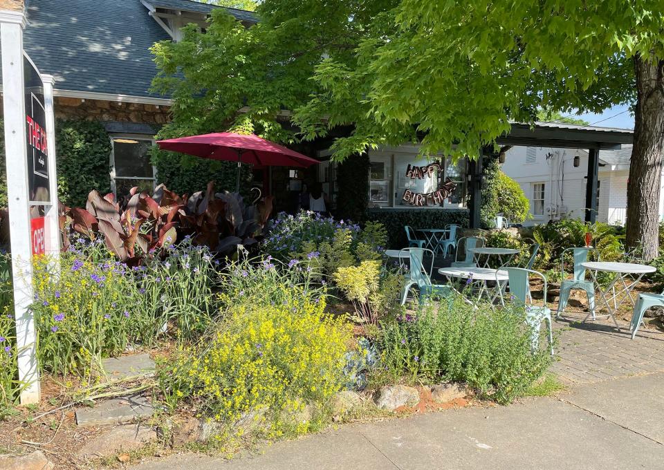 The patio dining area at The Cafe on Lumpkin in Athens seats customers under natural shade surrounded by lush vegetation on Tuesday, May 3, 2022.