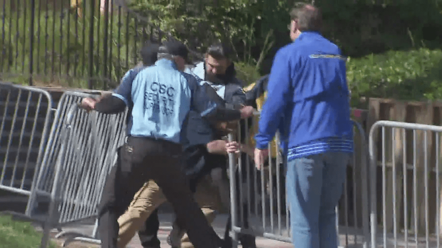 A man trying to access a public walkway is stopped by security at UCLA on April 30, 2024.