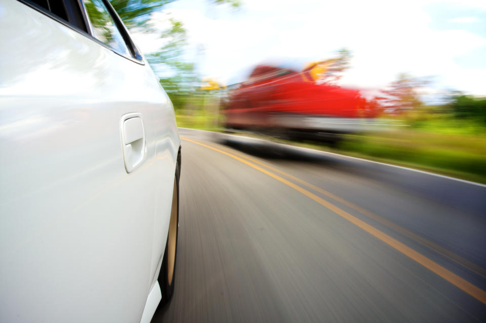 White car in motion on a road with blurred surroundings conveying speed