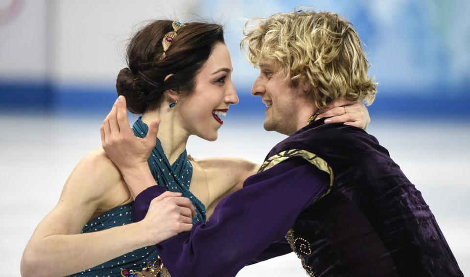 Meryl Davis, left, and Charlie White, of the United States, perform their free dance in the ice dance portion of the team figure skating event at the Winter Olympics, Sunday, Feb. 9, 2014, in Sochi, Russia. (AP Photo/The Canadian Press, Paul Chiasson)