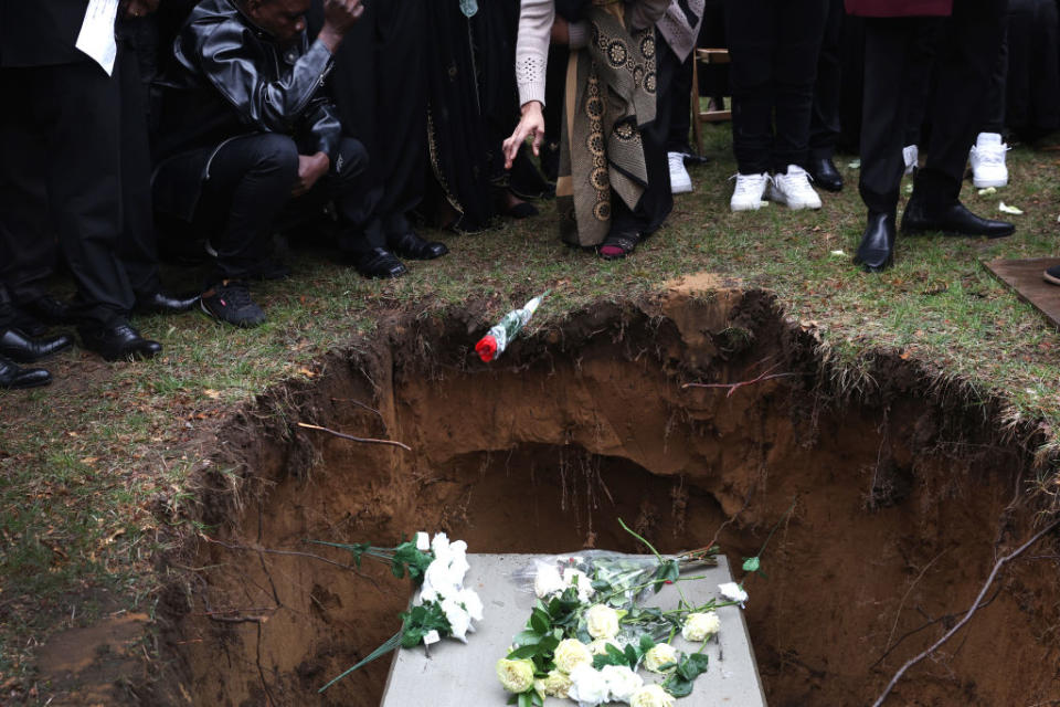 A flower is tossed into the grave of Patrick Lyoya as he is laid to rest at Resurrection Cemetery on April 22, 2022 in Wyoming, Mich.<span class="copyright">Scott Olson—Getty Images</span>