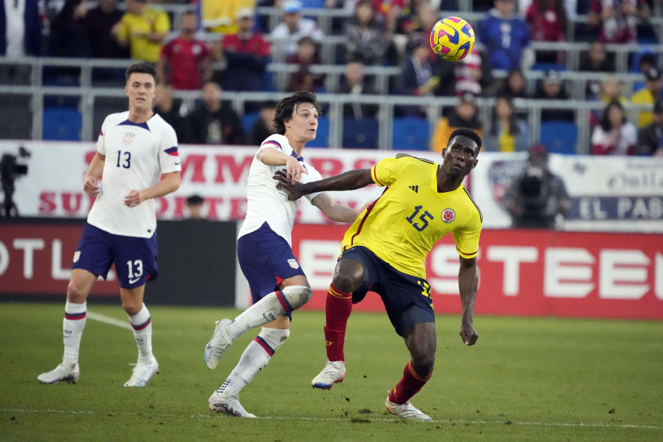 Colombia's Yilmar Velazquez, right, is defended by United States' Paxten Aaronson during the first half of an international friendly soccer match Saturday, Jan. 28, 2023, in Carson, Calif. (AP Photo/Marcio Jose Sanchez)