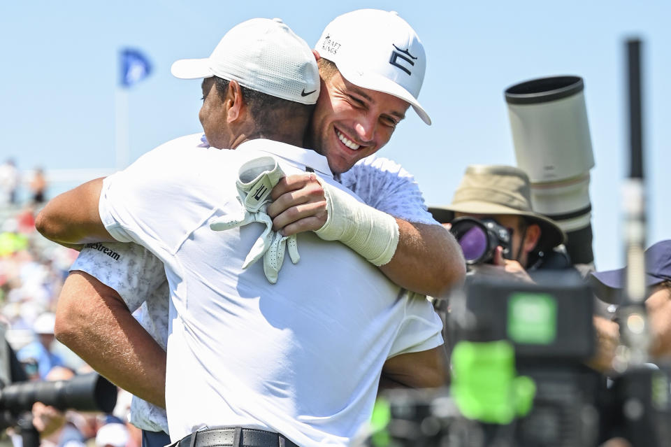 TULSA, OK - MAY 18:  Tiger Woods hugs Bryson DeChambeau during practice for the PGA Championship at Southern Hills Country Club on May 18, 2022, in Tulsa, Oklahoma. (Photo by Keyur Khamar/PGA TOUR via Getty Images)