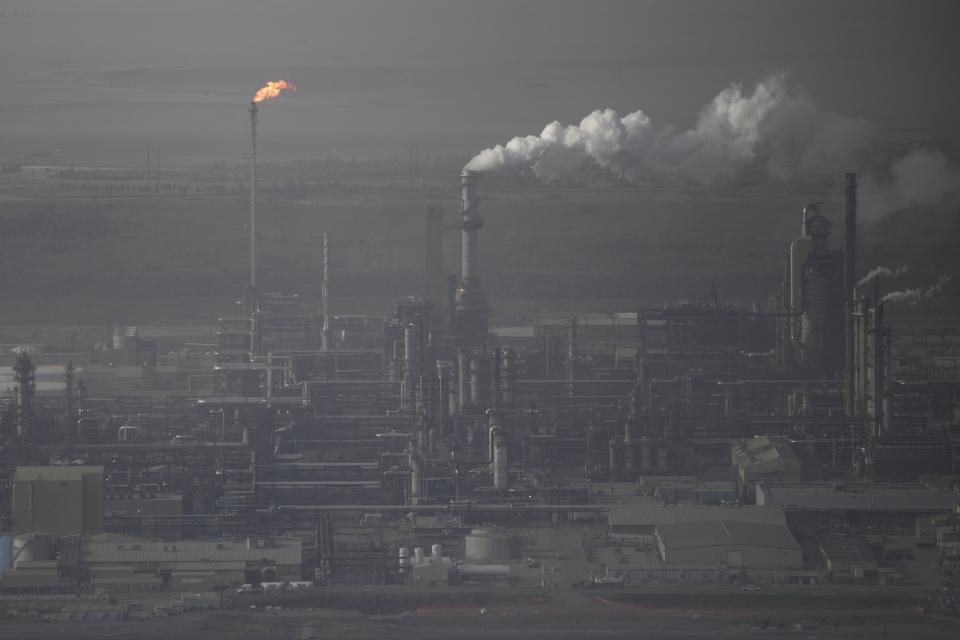 Steam rises at Suncor's oil sands facility near Fort McMurray, Canada, on Friday, Sep. 1, 2023. Wildfires are bringing fresh scrutiny to Canada's fossil fuel dominance, its environmentally friendly image and the viability of becoming carbon neutral by 2050.(AP Photo/Victor R. Caivano)