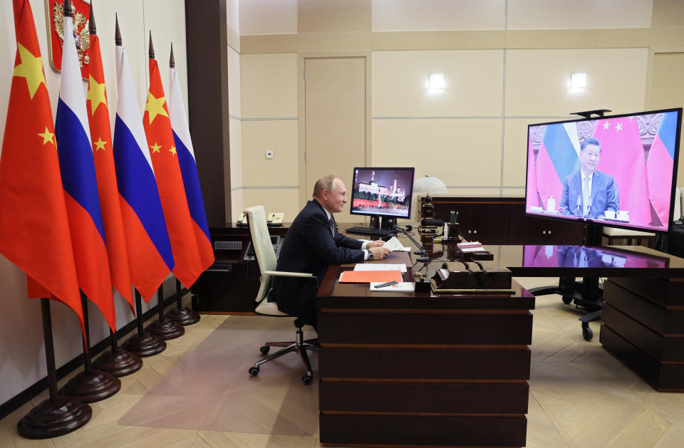 Russian President Vladimir Putin speaks with Chinese President Xi Jinping, right on the screen, via videoconference in Moscow, Russia, Wednesday, Dec. 15, 2021. Russian President Vladimir Putin and Chinese leader Xi Jinping have held a video call to discuss bilateral relations and international affairs. The summit Wednesday comes amid heightened tensions between Moscow and the West over a Russian troop buildup near Ukrainian borders that is stoking fears of a possible invasion. (Mikhail Metzel, Sputnik, Kremlin Pool Photo via AP)