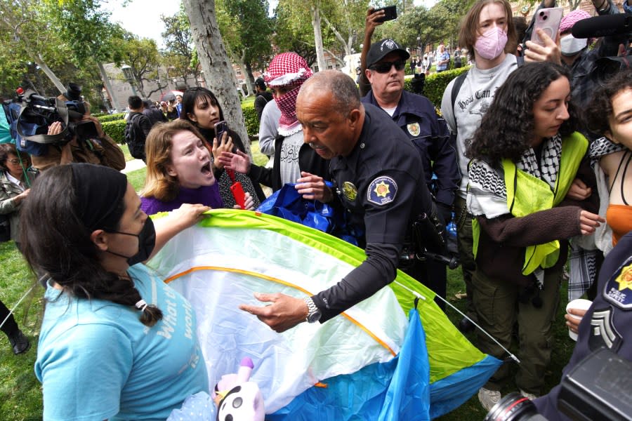 University of Southern California protesters fight with University Public Safety officers as they try to remove tents at the campus’ Alumni Park during a pro-Palestinian occupation on Wednesday, April 24, 2024 in Los Angeles. (AP Photo/Richard Vogel)