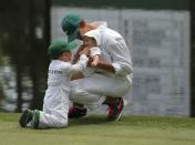 Angie Watson, wife of U.S. golfer Bubba Watson, looks on as their son Caleb (L) plays with his sister Dakota during the par 3 event held ahead of the 2015 Masters at Augusta National Golf Course in Augusta, Georgia April 8, 2015. REUTERS/Brian Snyder