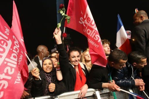 Supporters of Socialist Party (PS) candidate for the 2012 French presidential election celebrate at Place de la Bastille in Paris after the announcement of the first official results of the French presidential second round