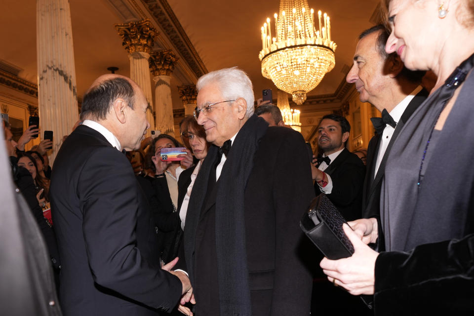 Italian President Sergio Mattarella, center, is received by La Scala Superintendent Dominique Meyer as he arrives for the premiere of Modest Mussorgsky's Boris Godunov in Milan, Italy, Wednesday, Dec. 7, 2022. Italy’s most famous opera house, Teatro alla Scala, opened its new season Wednesday with the Russian opera “Boris Godunov,” against the backdrop of Ukrainian protests that the cultural event is a propaganda win for the Kremlin during Russia’s invasion of Ukraine. (AP Photo/Antonio Calanni)