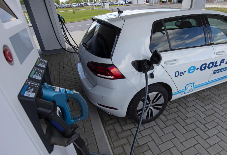 FILE -- An electric car is charged at a charging station during a press tour of the plant of the German manufacturer Volkswagen AG (VW) in Zwickau, Germany, Tuesday, May 14, 2019. Germany’s government wants to massively expand the country’s charging network for electric cars with 6.3 billion euros ($6.17 billion) over the next three years as it expects more and more drivers to turn from combustion cars to more climate-friendly electromobility. (AP Photo/Jens Meyer, file)