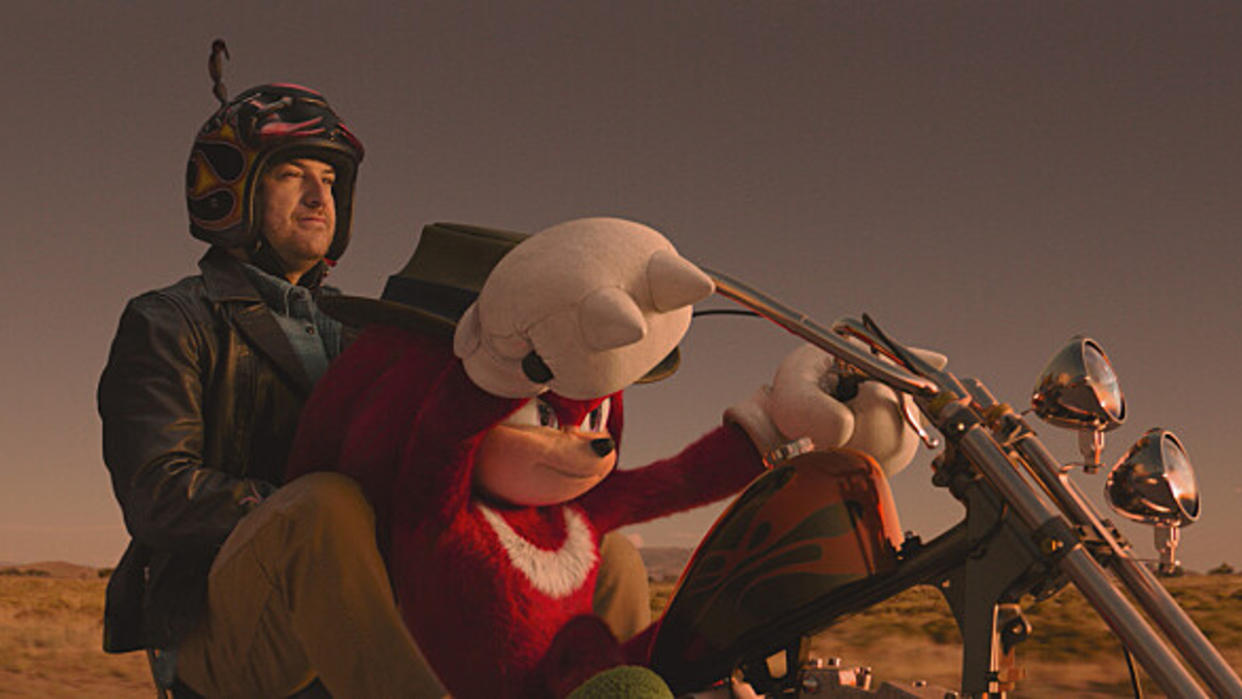  Knuckles and Wade riding a motorcycle in Knuckles. 