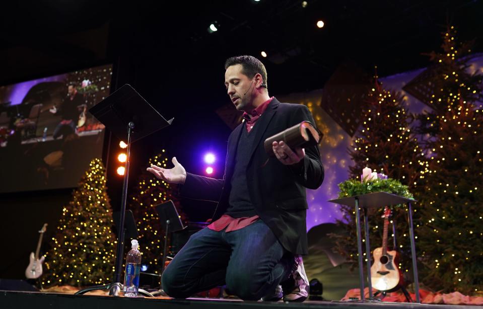 Pastor Craig McGlassion of Kensington Church leads a holiday service on Christmas Eve at the church's Lake Orion campus on December 24, 2021.