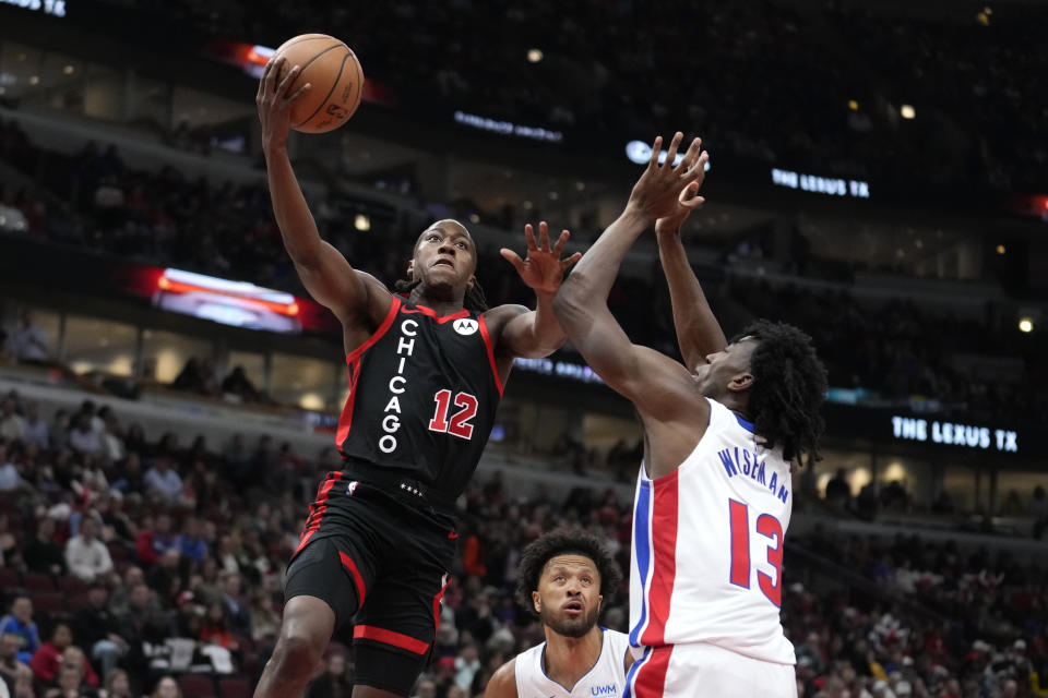 Chicago Bulls' Ayo Dosunmu (12) drives to the basket as Detroit Pistons' James Wiseman defends during the first half of an NBA basketball game Tuesday, Feb. 27, 2024, in Chicago. (AP Photo/Charles Rex Arbogast)