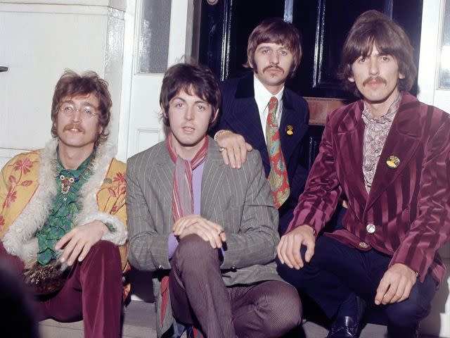 <p>Jeff Hochberg/Getty</p> John Lennon, Paul McCartney, Ringo Starr and George Harrison of The Beatles attend a press party at the home of manager Brian Epstein on May 19, 1967, in London, United Kingdom.