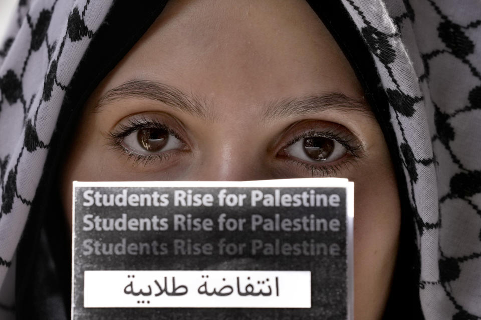 A student holds a placard during a protest inside the American University of Beirut to show support for Palestinians in the Gaza Strip, in Beirut, Lebanon, Tuesday, May 7, 2024. (AP Photo/Bilal Hussein)