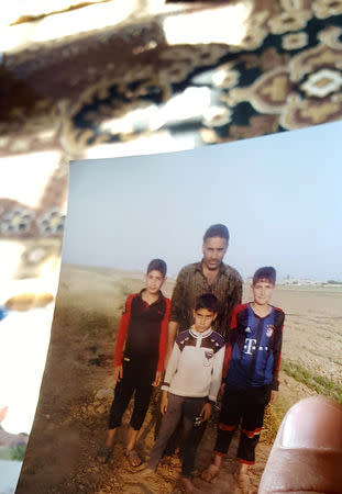 The childhood photo of teenage Islamic State militant Atheer Ali is seen in Mosul, Iraq, February 4, 2017. Picture taken February 4, 2017. REUTERS/Stephen Kalin