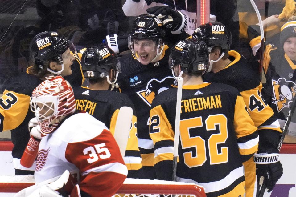 The Penguins' Drew O'Connor, center, celebrates his goal against the Red Wings during the first period in Pittsburgh on Wednesday, Dec. 28, 2022.