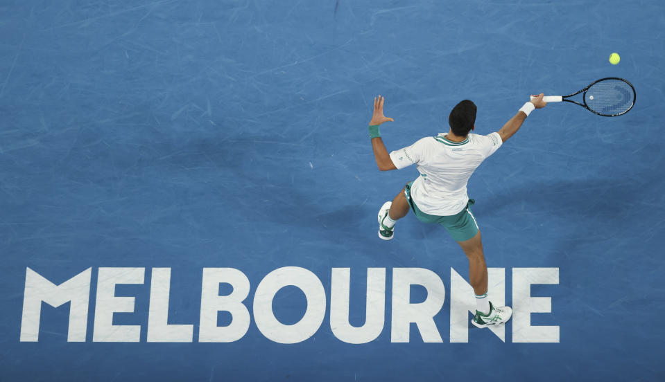 Serbia's Novak Djokovic hits a forehand return to Russia's Aslan Karatsev during their semifinal match at the Australian Open tennis championship in Melbourne, Australia, Thursday, Feb. 18, 2021.(AP Photo/Hamish Blair)