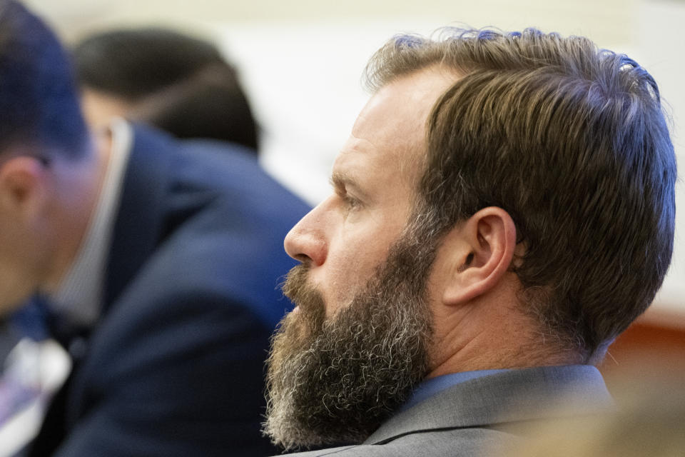 Defendant Matthew Collins looks on as his attorney Jared Ausserer gives closing arguments during the trial of three police officers in the killing of Manny Ellis at Pierce County Superior Court, Wednesday, Dec. 13, 2023, in Tacoma, Wash. Tacoma Police Officers Christopher Burbank, Matthew Collins and Timothy Rankine stand trial for charges related to the March 2020 killing of Manny Ellis. (Brian Hayes/The News Tribune via AP, Pool)