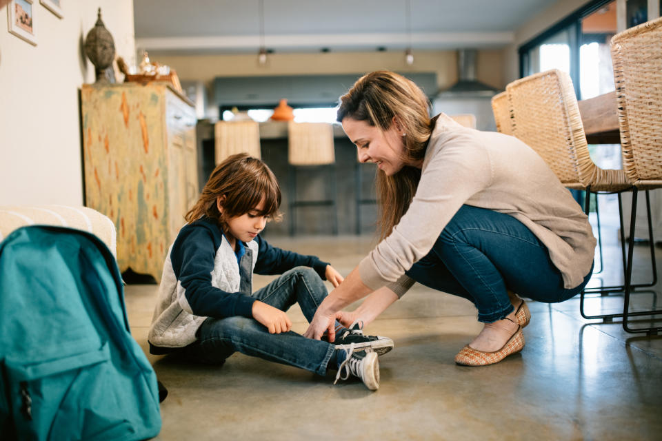 Mother helping son get ready for school