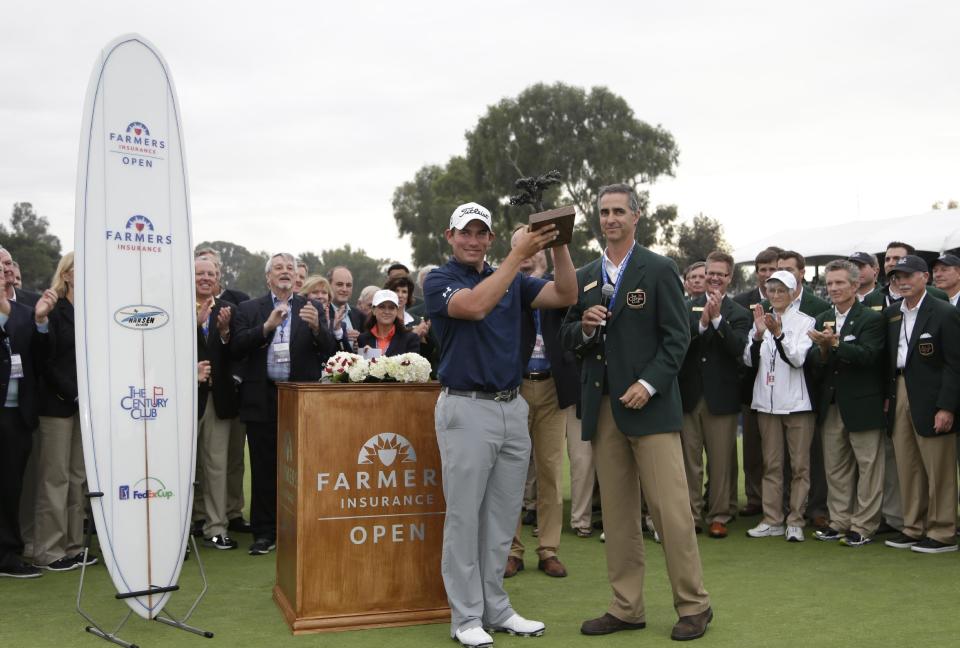 Scott Stallings holds the trophy after winning the Farmers Insurance Open golf tournament, Sunday, Jan. 26, 2014, in San Diego. (AP Photo/Gregory Bull)