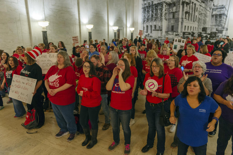 CORRECTS DAY OF WEEK TO WEDNESDAY - Teachers and school personnel, on the second day of a statewide strike, demonstrate outside the House of Delegates chamber, Wednesday, Feb. 20, 2019, at the West Virginia State Capitol in Charleston, W.Va. West Virginia public school teachers are striking for a second day even though legislation they loathed was tabled in the House of Delegates. Schools in 54 of the state's 55 counties were closed Wednesday. The lone holdout again was Putnam County. (Craig Hudson/Charleston Gazette-Mail via AP)