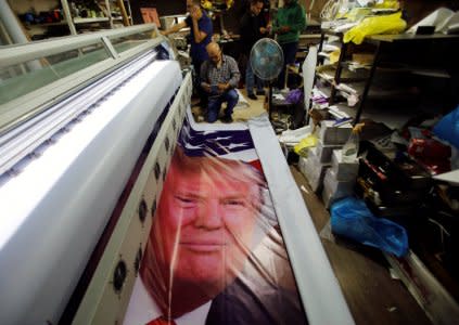 Palestinians print posters depicting U.S. President Donald Trump in preparations for his planned visit, in the West Bank town of Bethlehem May 21, 2017. REUTERS/Mussa Qawasma