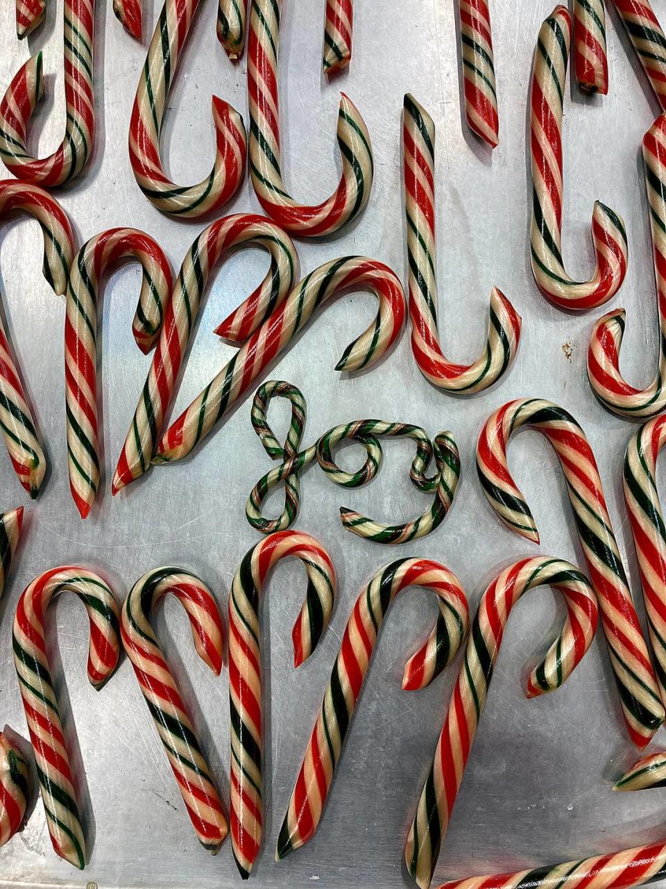 Peter Vrinios makes candy canes atop his family’s antique candy table at the Fudge Factory in Bradenton Beach. Vrinios’ family has been making candy for four generations and has been putting on a candy show during the holidays. provided