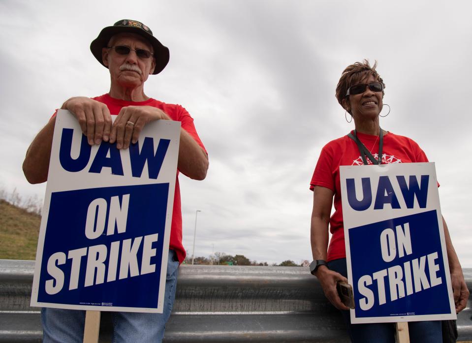 Robert “Bart” Bartenbach and Angie Osborn, workers at the Spring Hill General Motors plant, picket outside of the plant after United Auto Workers Local 1853 announced a strike after 44 days of negotiations with GM in Spring Hill, Tenn., Sunday, Oct. 29, 2023.