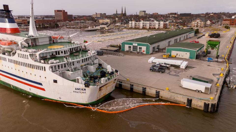 Earlier this week, drone footage showed a boom surrounding MV Ancier as it sat docked at Charlottetown in the mouth of the Hillsborough River. (Shane Hennessey/CBC - image credit)