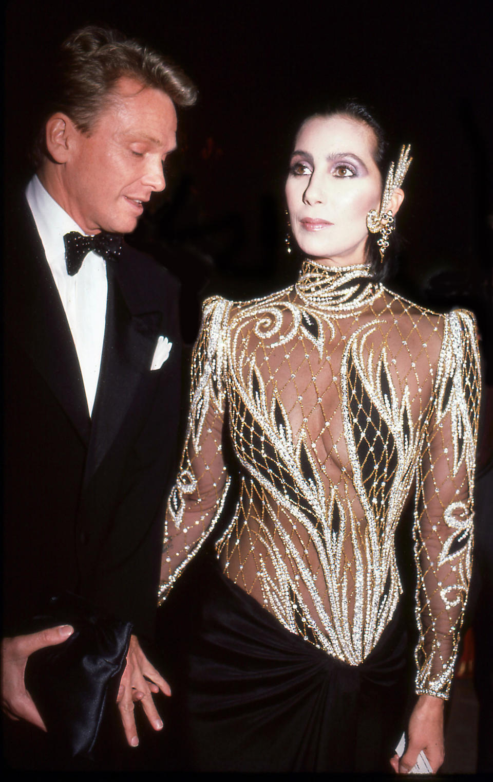 Designer Bob Mackie and the singer and actress Cher attend the Costume Institute Gala at the Metropolitan Museum of Art, New York, New York, 1985. / Credit: Rose Hartman/Getty Images