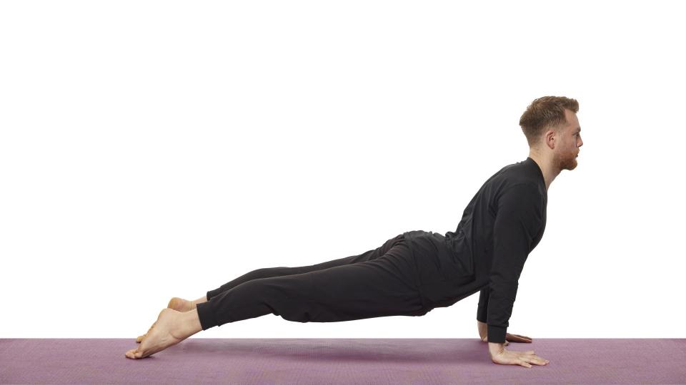 Yoga teacher Nick Higgins performs cobra pose