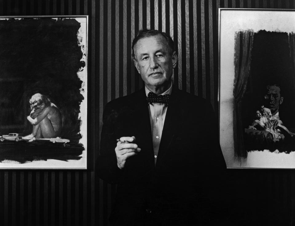 British author and creator of James Bond Ian Fleming (1908-1964) with two pieces of original artwork from the American hardback editions of his books, circa 1960.  (Photo by Horst Tappe/Hulton Archive/Getty Images)