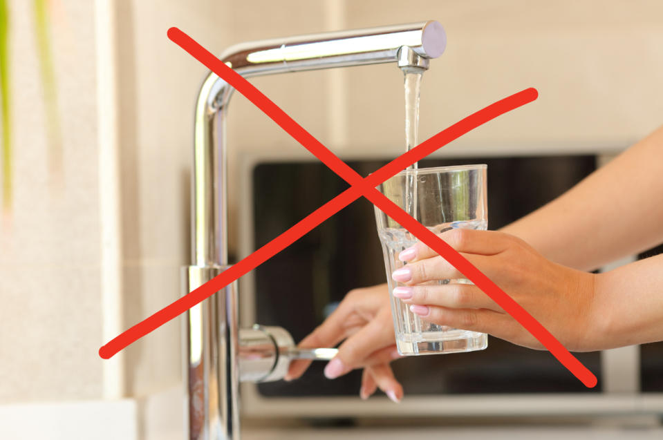 A red X over a glass of water under a faucet