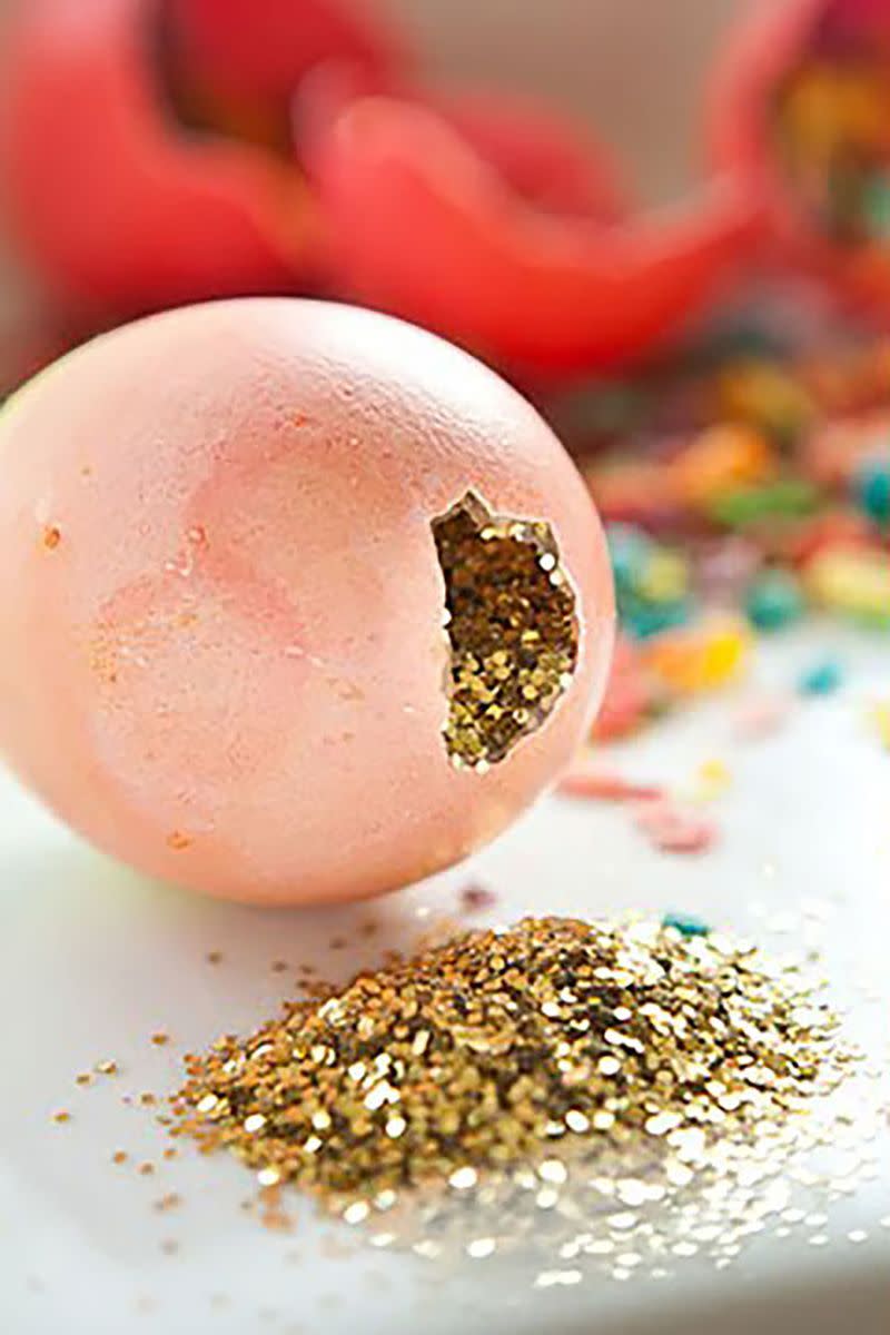 pink easter egg cracked to reveal gold glitter inside