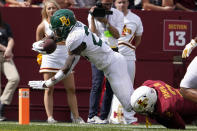 Baylor running back Richard Reese (29) scores on a 19-yard touchdown run ahead of Iowa State defensive back T.J. Tampa (2) during the second half of an NCAA college football game, Saturday, Sept. 24, 2022, in Ames, Iowa. Baylor won 31-24. (AP Photo/Charlie Neibergall)