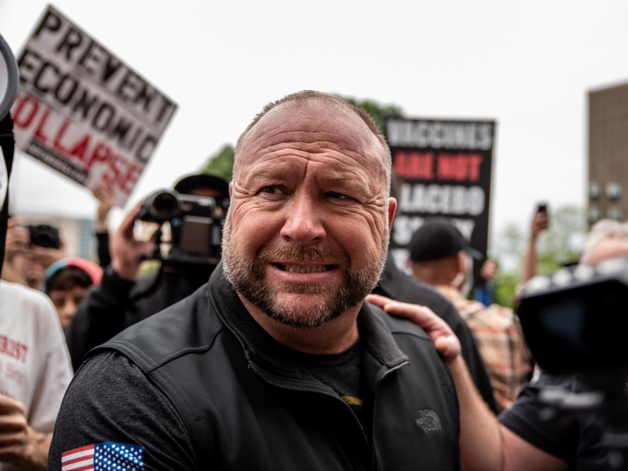 <p>Infowars founder Alex Jones interacts with supporters at the Texas State Capital building on 18 April 2020 in Austin, Texas</p> ((Getty Images))