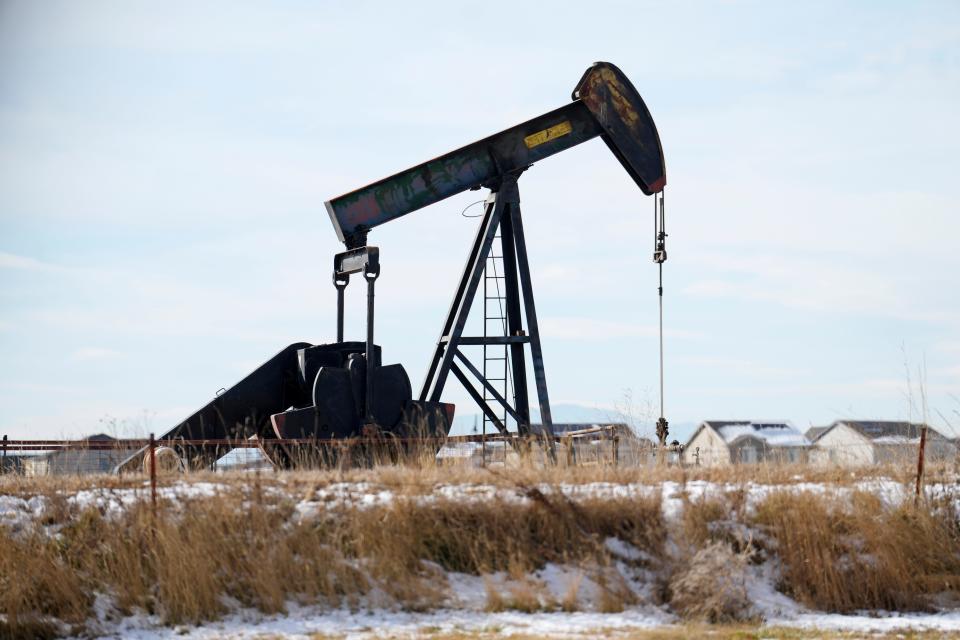 An oil pumper stands in a field along Interstate 25 on Thursday, Nov. 30, 2023, near Erie, Colo. (AP Photo/David Zalubowski) ORG XMIT: OTKDZ125