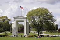 In this photo taken May 17, 2020, people walk back and forth across the border between the U.S. and Canada in Peace Arch Park in Blaine, Wash. With the border closed to nonessential travel amid the global pandemic, families and couples across the continent have found themselves cut off from loved ones on the other side. But the recent reopening of Peace Arch Park, which spans from Blaine into Surrey, British Columbia, at the far western end of the 3,987-mile contiguous border, has given at least a few separated parents, siblings, lovers and friends a rare chance for some better-than-Skype visits. (AP Photo/Elaine Thompson)