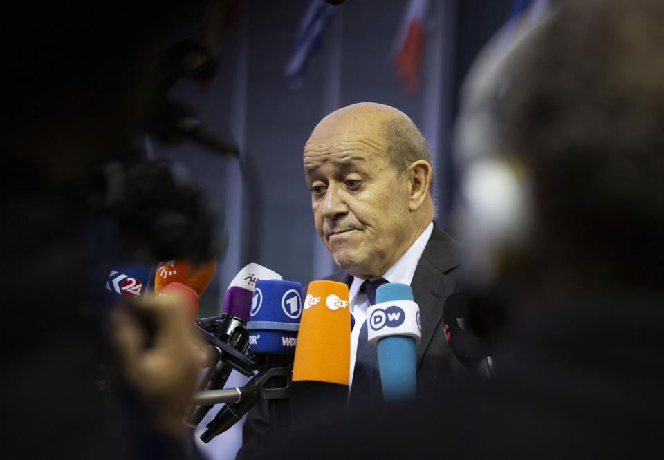 French Foreign Minister Jean-Yves Le Drian speaks with the media as he arrives for a meeting of EU foreign ministers at the European Convention Center in Luxembourg, Monday, Oct. 14, 2019. Some European Union nations are looking to extend moves against Turkey by getting more nations to ban arms exports to Ankara to protest the offensive in neighboring Syria. (AP Photo/Virginia Mayo)