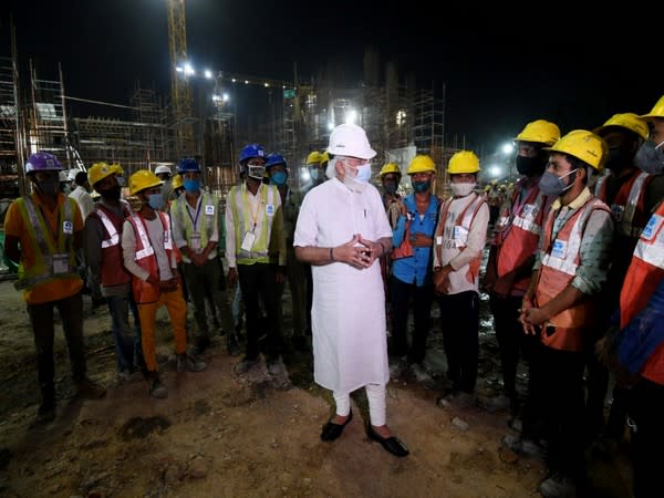 PM Modi interacts with workers engaged in the construction of the new Parliament building.