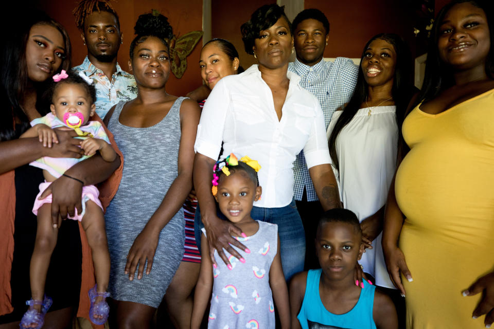 Mason, center, with her daughter Taylor, far left, and her biological children, adoptive children and grandkids that she raised in her home in Rendon, Texas. (Photo: Allison V. Smith for HuffPost)