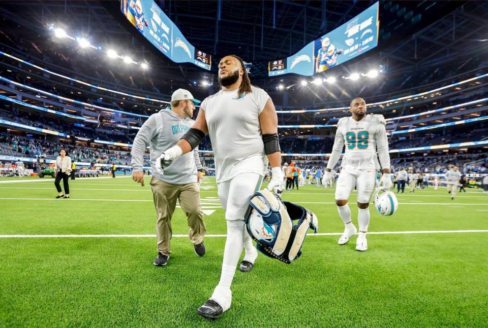 Miami Dolphins offensive tackle Robert Hunt (68) and defensive tackle Raekwon Davis (98) walk off the field after the Los Angeles Chargers defeat the Dolphins at SoFi Stadium in Inglewood, California on Sunday, December 11, 2022.