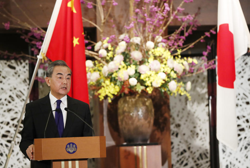 China' Foreign Minister Wang Yi, left, and his Japanese counterpart Toshimitsu Motegi (unseen) participate in a press briefing in Tokyo on Tuesday, Nov. 24, 2020. Wang met Motegi on Tuesday to discuss ways to revive their pandemic-hit economies as well as regional concerns over China’s growing influence. (Issei Kato/Pool Photo via AP)