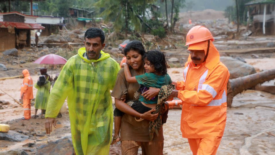 Rescuers help residents move to a safer place after multiple landslides hit Wayanad, in the southern state of Kerala, India, on July 30, 2024. - Stringer/Reuters