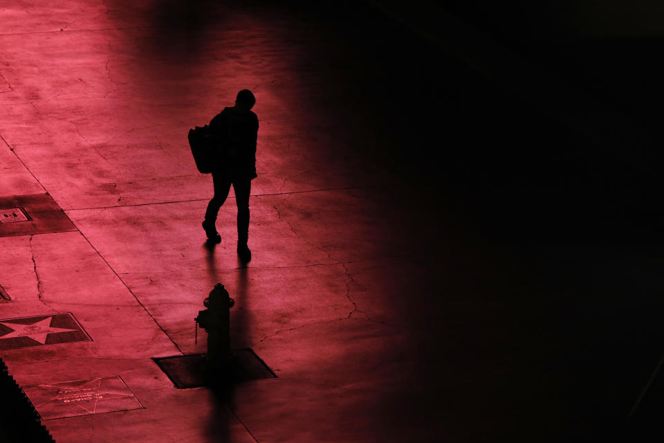 FILE - A person walks along the Las Vegas Strip devoid of the usual crowds after casinos have been ordered to shut down due to the coronavirus, March 18, 2020, in Las Vegas. Loneliness in America can be deadly. In May 2023, U.S. Surgeon General Vivek Murthy declared it an American epidemic, saying that it takes as deadly a toll as smoking upon the population of the United States. “Millions of people in America are struggling in the shadows," he said, “and that’s not right.” (AP Photo/John Locher, File)