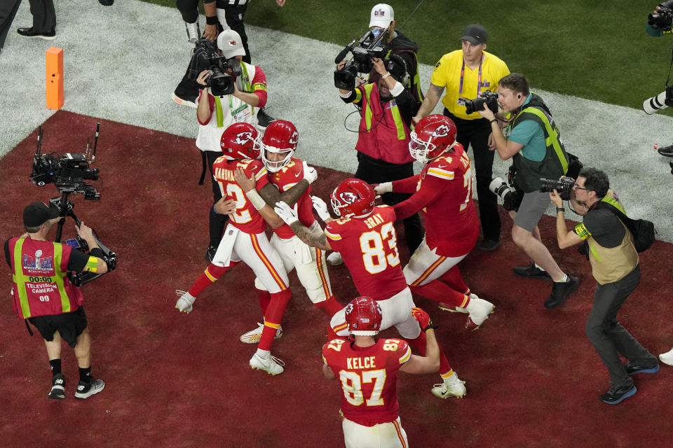 Kansas City Chiefs quarterback Patrick Mahomes, center, celebrates with wide receiver Mecole Hardman Jr. (12) after throwing the game-wining touchdown during overtime of the NFL Super Bowl 58 football game against the San Francisco 49ers Sunday, Feb. 11, 2024, in Las Vegas. (AP Photo/David J. Phillip)