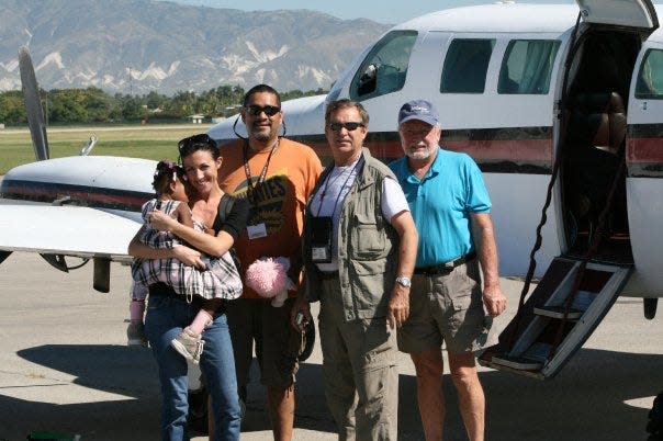 From left to right, Two-year-old Mishna Prezille, ABC reporter Marci Rand, FLORIDA TODAY Engagement Editor John A. Torres, missionary Joe Hurston and missionary Marlin Moudy get ready to leave Port-au-Prince on Jan. 16, 2010. They were later detained ib West Palm Beach on suspicion of trafficking.