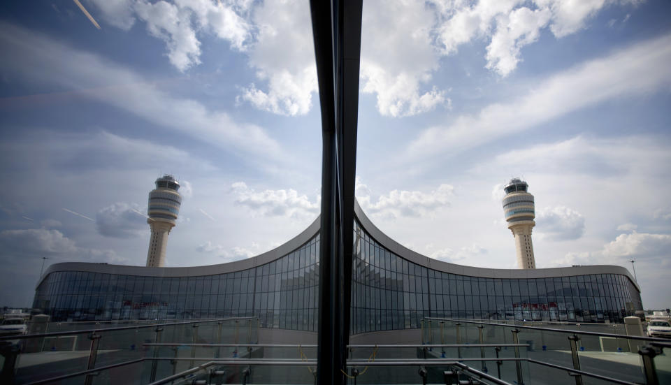 The new Maynard Holbrook Jackson Jr. International Terminal at Atlanta's airport is seen reflected in a window Wednesday, March 28, 2012. The new $1.4 billion international terminal at the world's busiest airport will be a sleek launching pad for millions of passengers that’s designed to help Atlanta grab a growing share of the lucrative market for global travelers. (AP Photo/David Goldman)